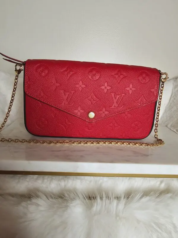 A red purse sitting on top of a table.