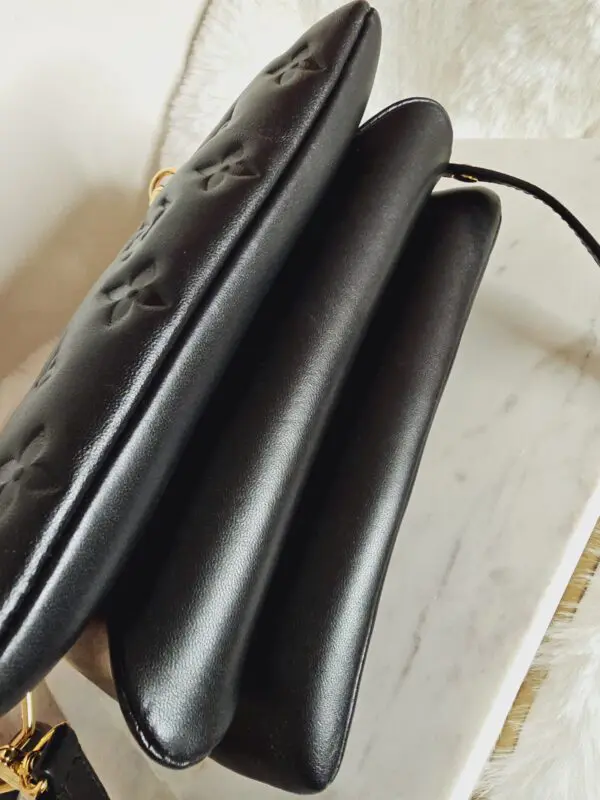 A close up of three black hair dryers