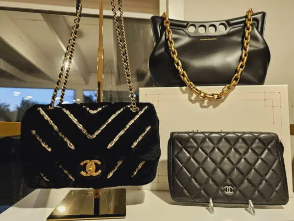 A wall with three different types of purses on it.