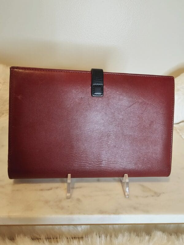 A red leather case sitting on top of a table.