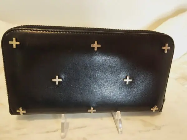 A black purse with crosses on it