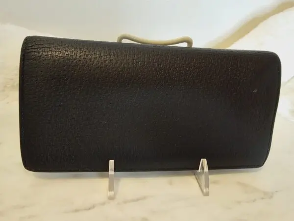 A black purse sitting on top of a counter.