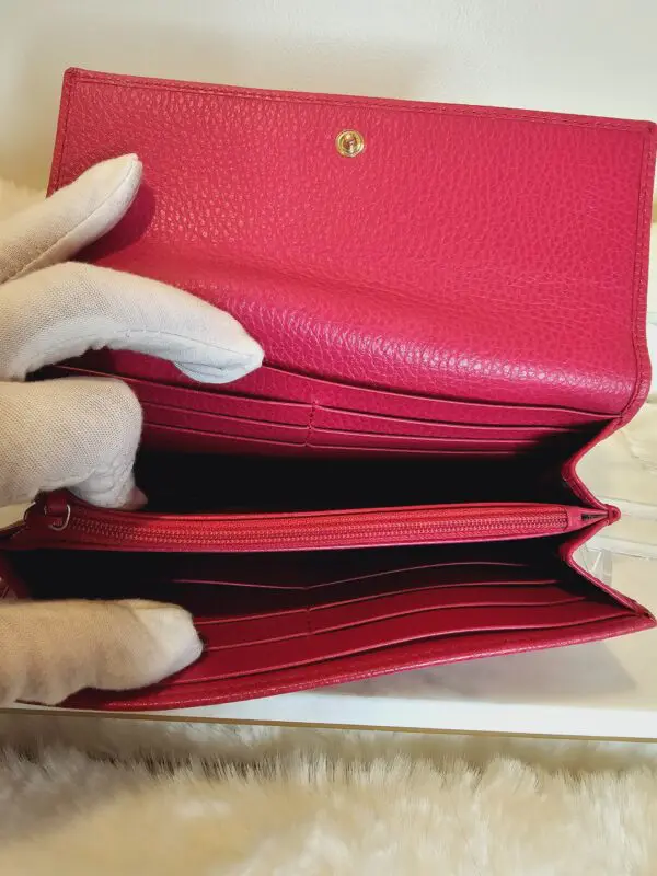 A person holding onto the inside of their wallet