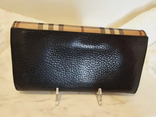 A black purse sitting on top of a counter.