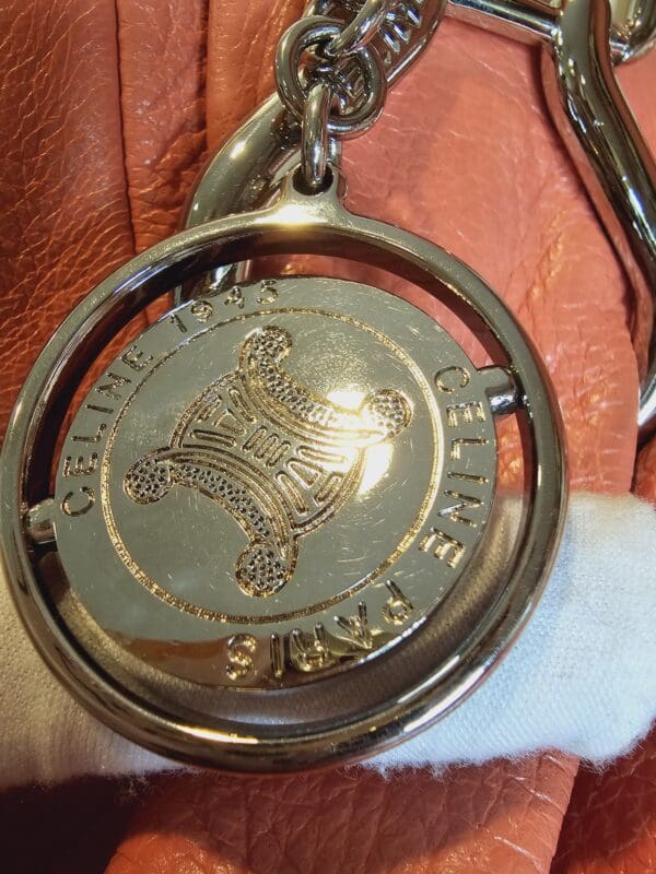 A close up of the key chain with a coin