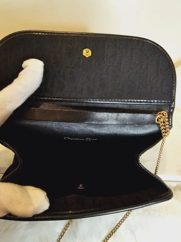 A person holding onto the inside of a purse