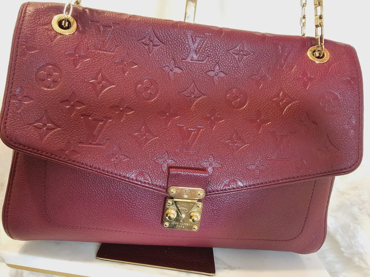 A red purse sitting on top of a counter.