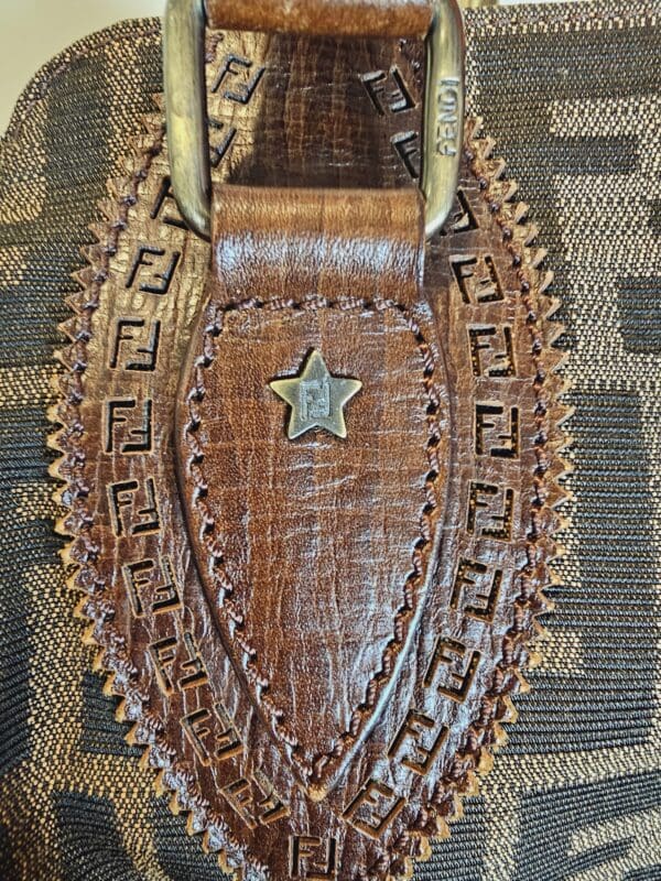 A brown leather purse with a star on it.