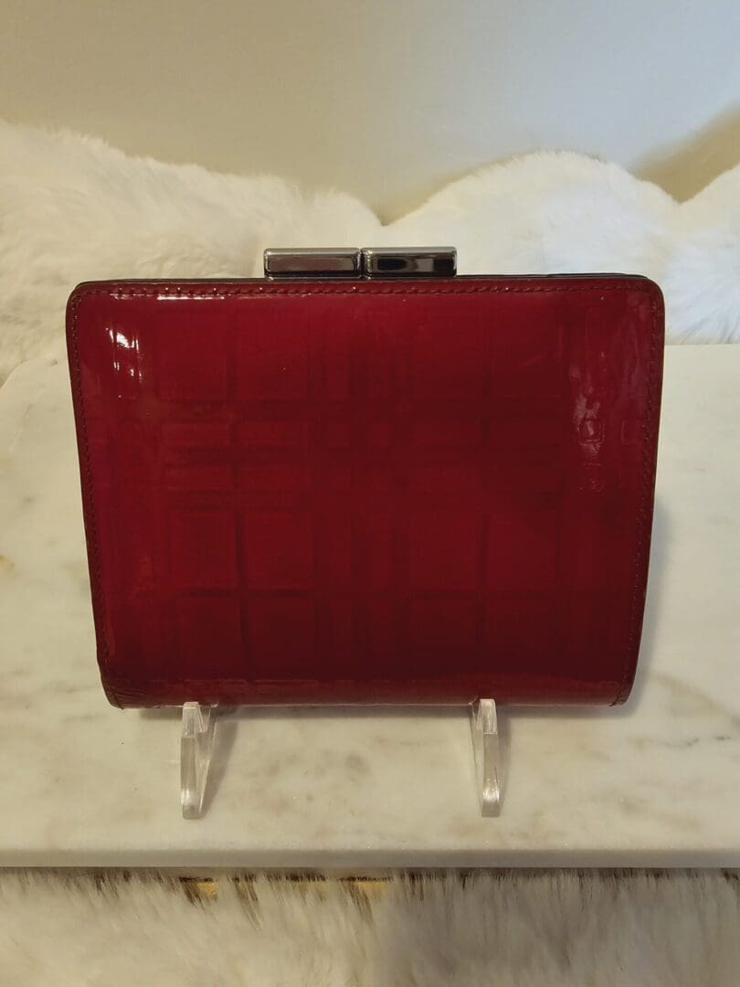 A red purse sitting on top of a table.