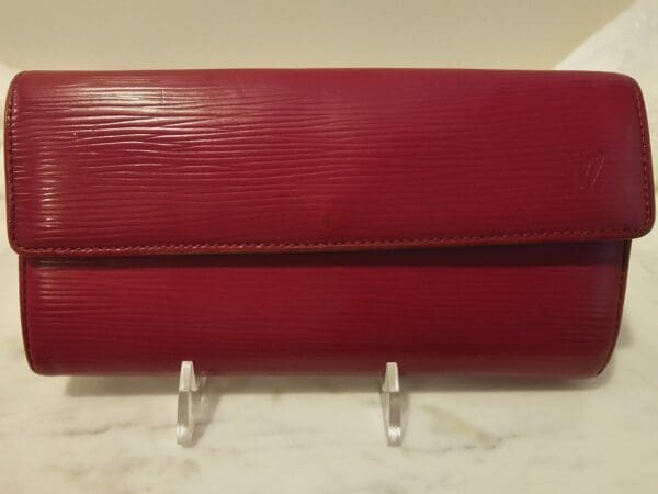 A red purse sitting on top of a counter.