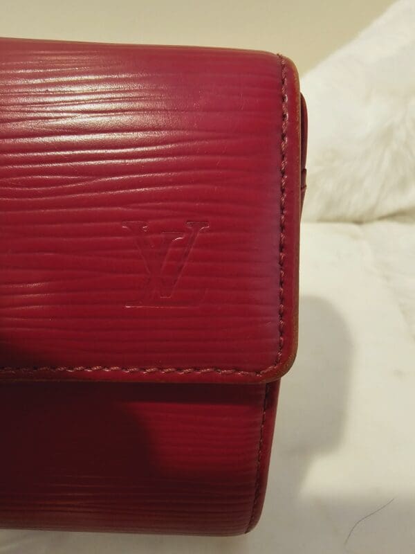 A close up of the red leather wallet