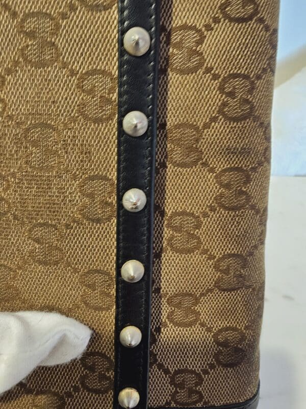 A close up of the leather strap on a chair