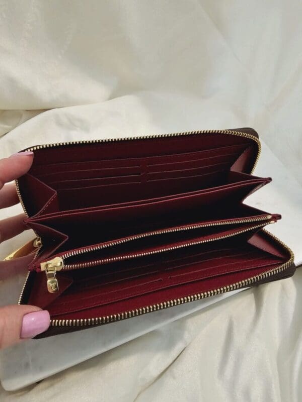 A person holding onto the inside of their wallet