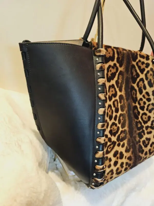 A close up of the bottom of a leopard print bag