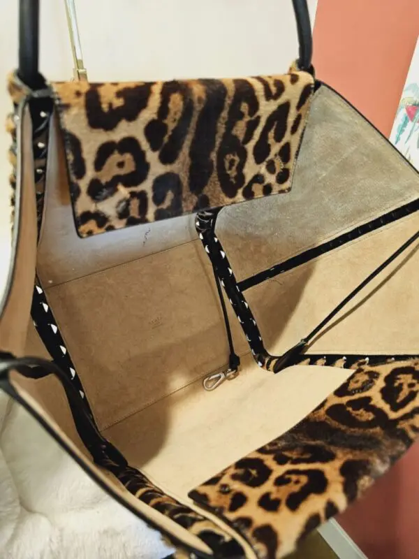 A leopard print purse sitting on top of a table.