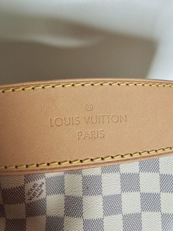 A close up of the louis vuitton logo on a bag