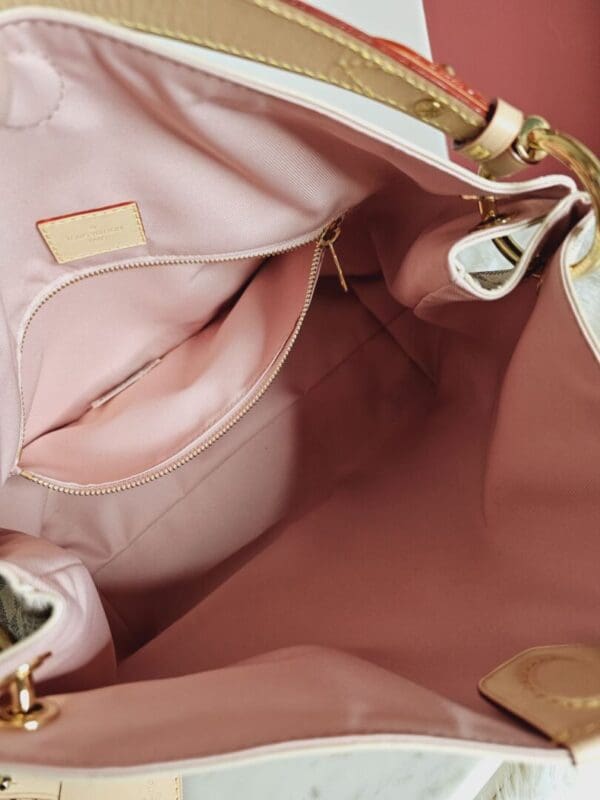 A close up of the inside of a pink purse