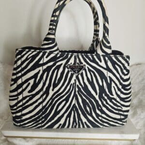 A zebra print purse sitting on top of a table.