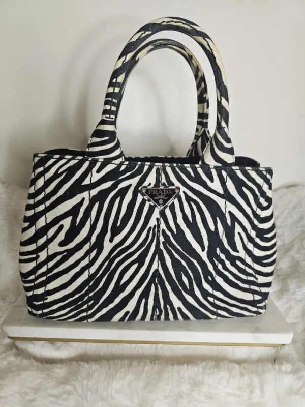 A zebra print purse sitting on top of a table.