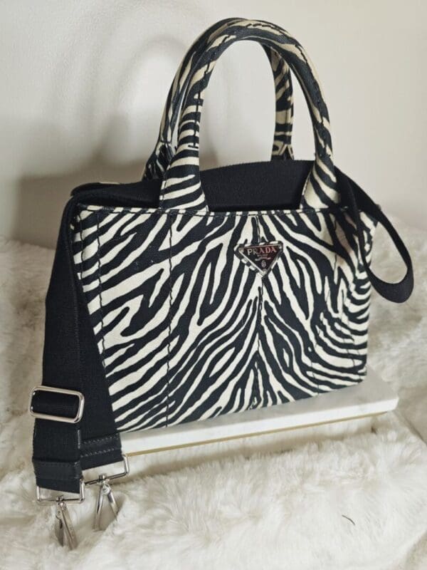 A zebra print purse sitting on top of a white table.