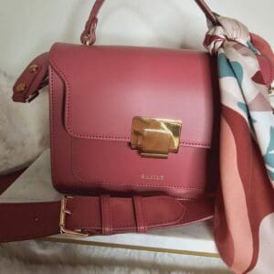 A red purse sitting on top of a table.