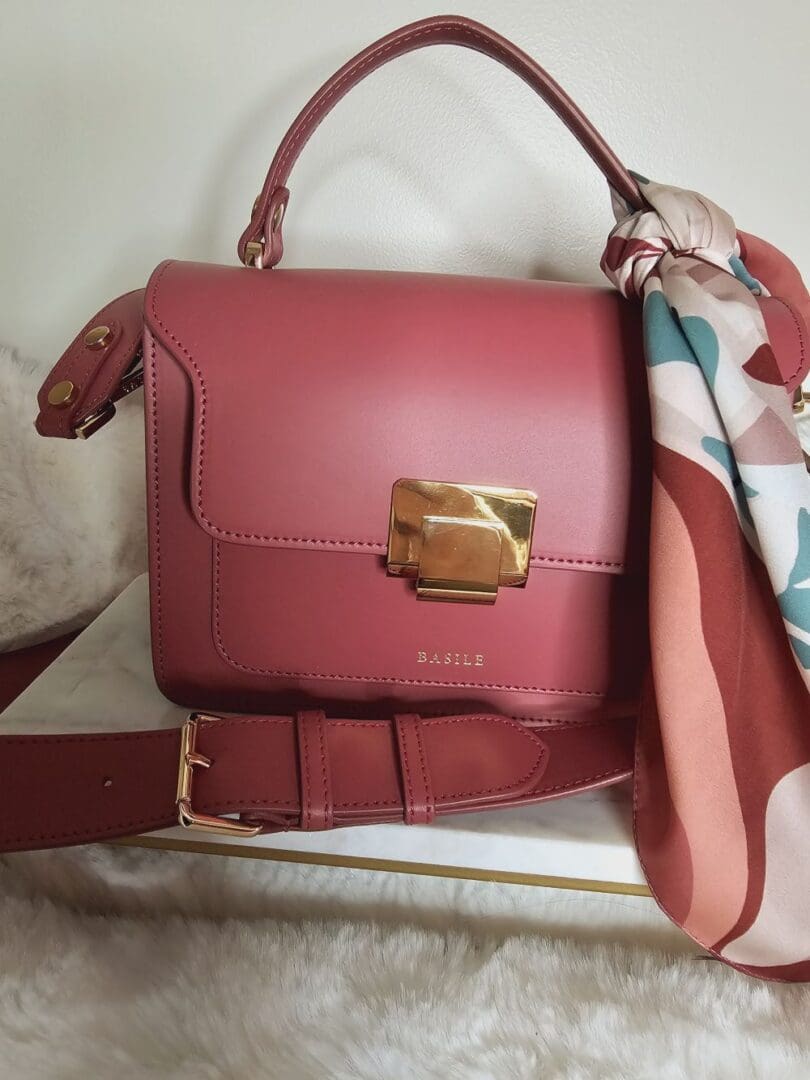 A red purse sitting on top of a table.