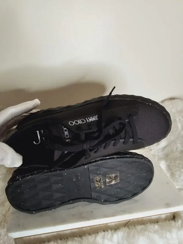 A pair of black shoes sitting on top of a white counter.