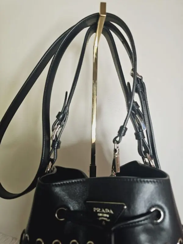 A black purse hanging on the wall