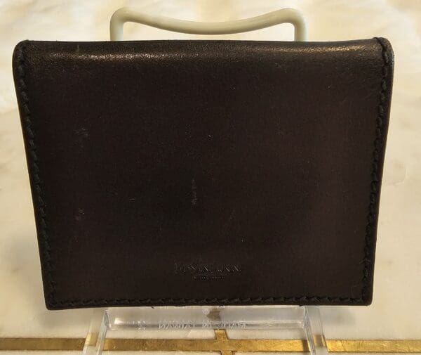 A black leather case sitting on top of a table.