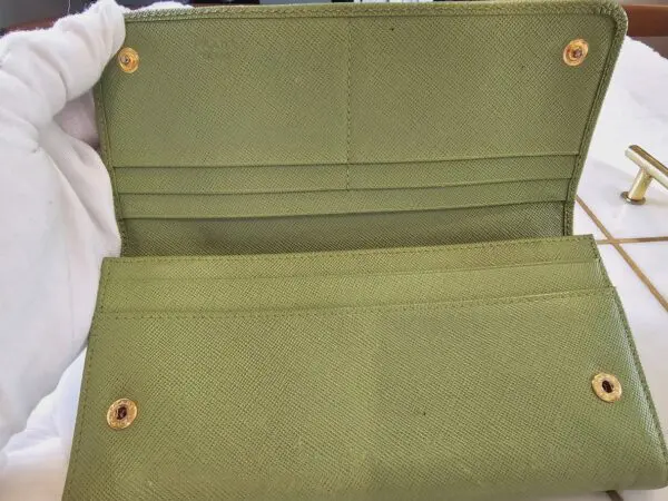 A green purse sitting on top of a table.