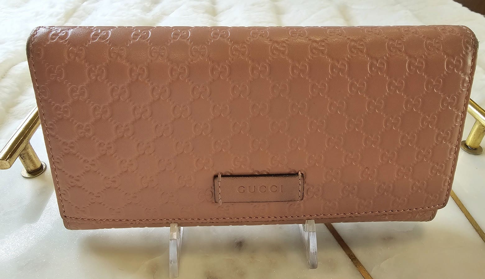 A brown wallet sitting on top of a wooden table.