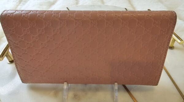 A brown leather wallet sitting on top of a table.