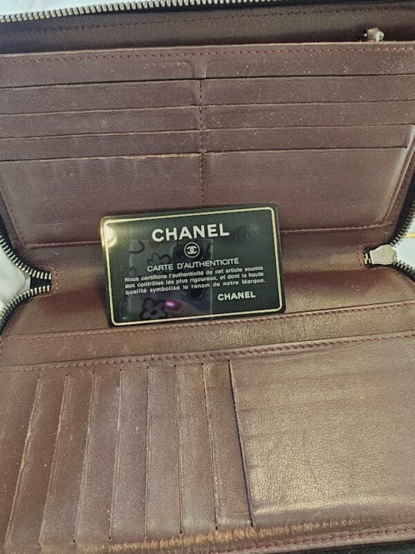 A close up of the chanel plaque on a bag