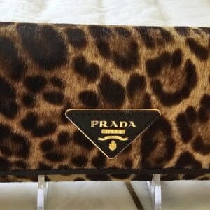 A close up of the prada logo on a purse