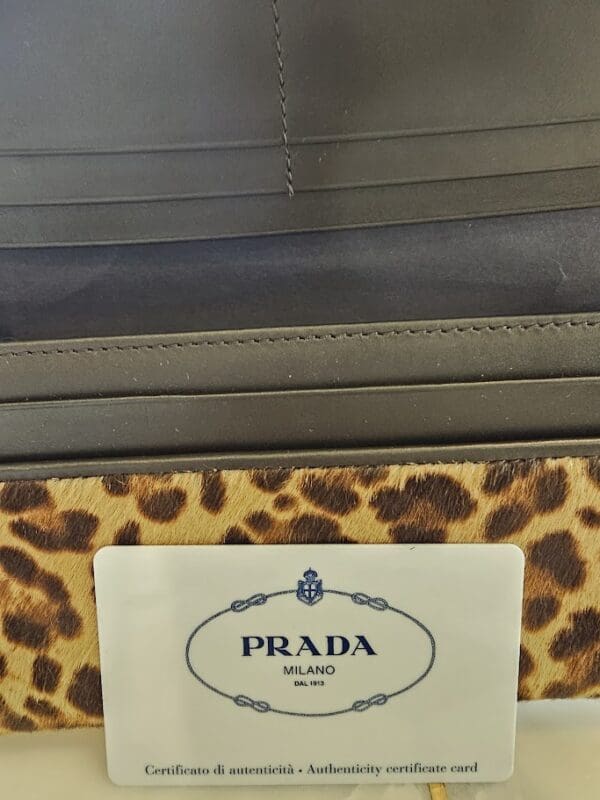 A close up of the prada logo on a purse