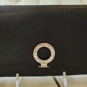 A black purse sitting on top of a table.