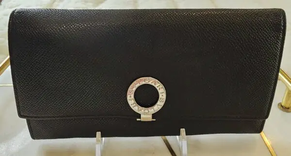 A black purse sitting on top of a table.