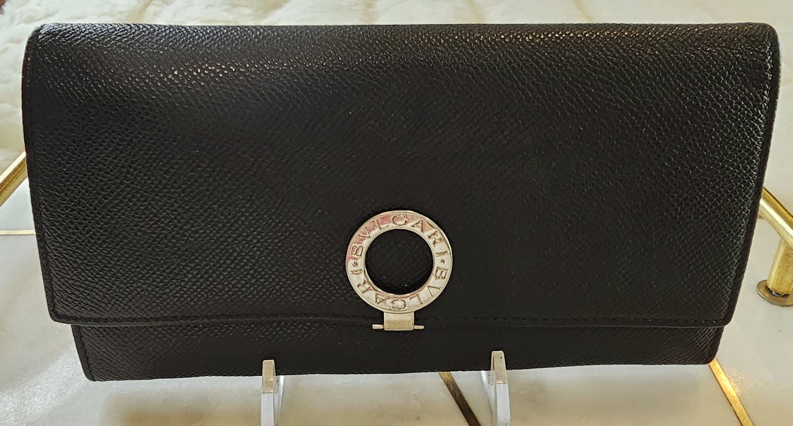 A black purse sitting on top of a table.