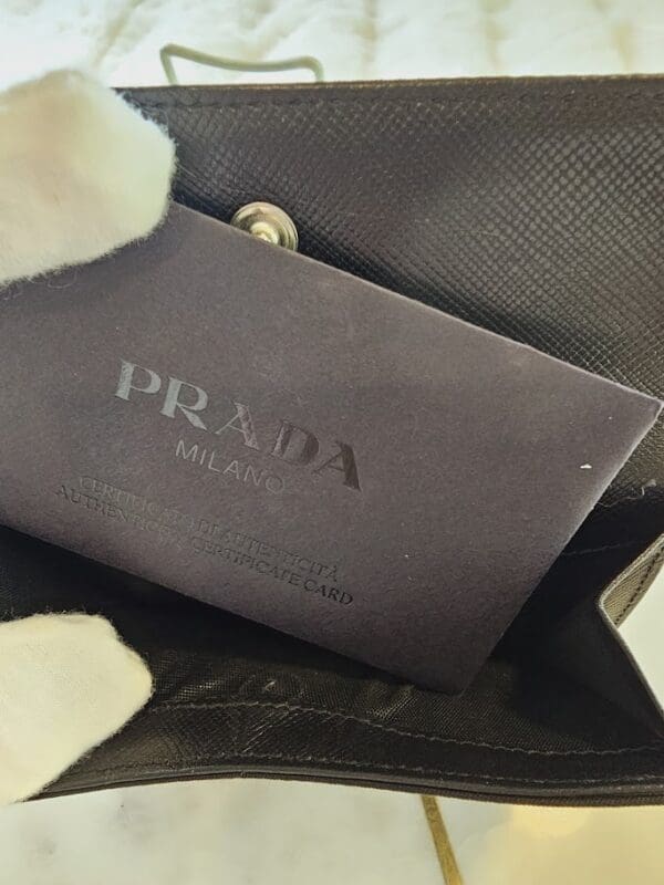 A close up of the prada logo on a purse