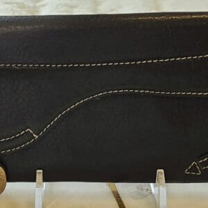 A black wallet with a string of gold thread.