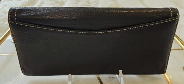 A black purse sitting on top of a table.