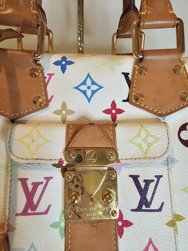 A close up of the front of a louis vuitton bag