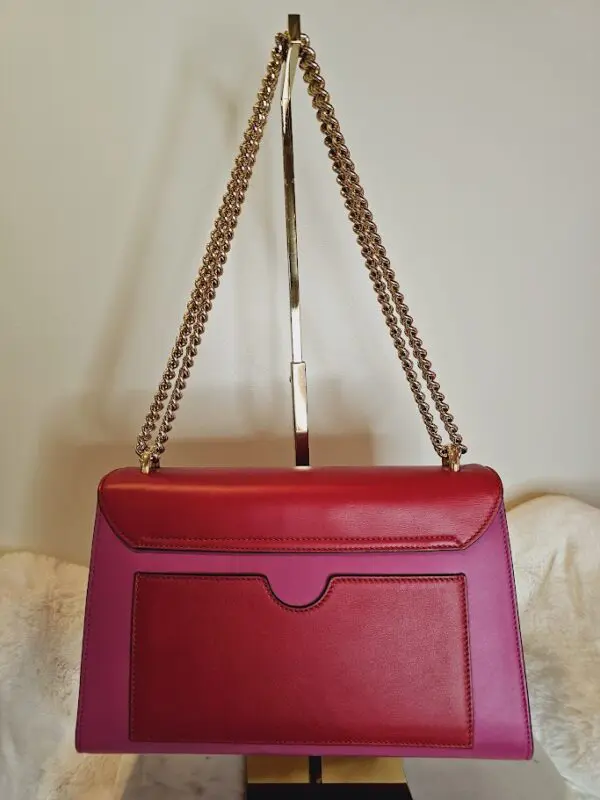 A red purse hanging on the wall