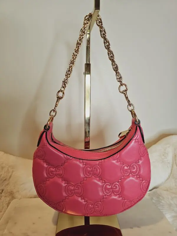 A pink purse hanging on the wall