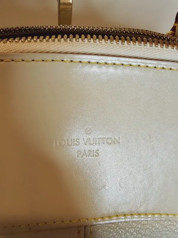 A close up of the louis vuitton logo on a bag