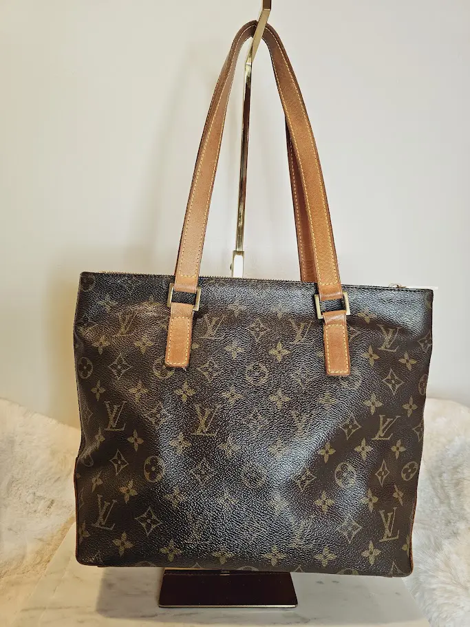 A brown and black bag sitting on top of a table.