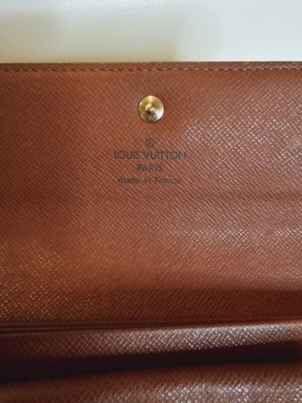 A close up of the inside of a louis vuitton wallet