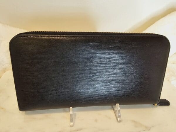 A black wallet sitting on top of a counter.