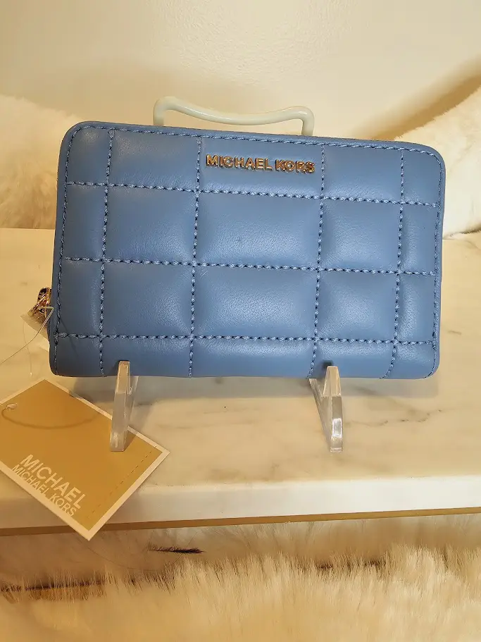 A blue wallet sitting on top of a table.