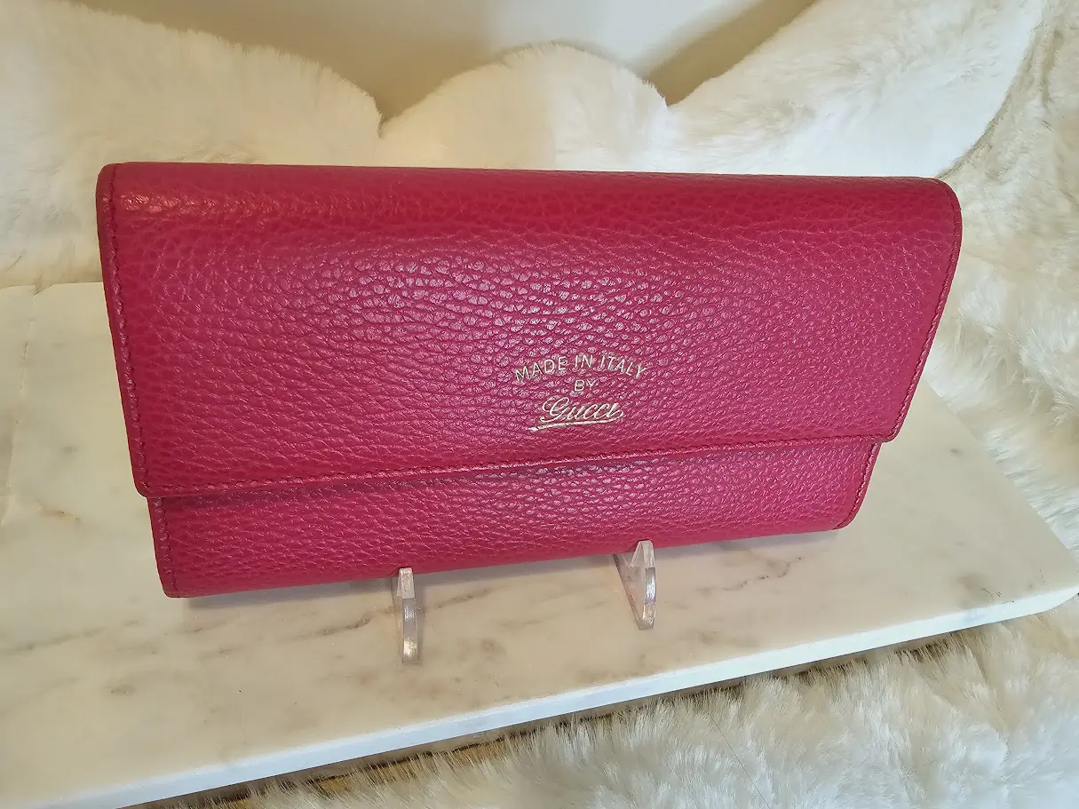 A red purse sitting on top of a table.